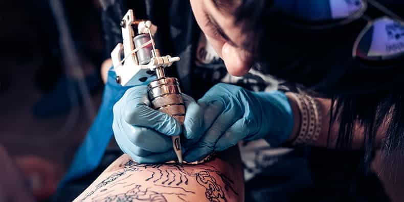 Tattoo artist designs his arm